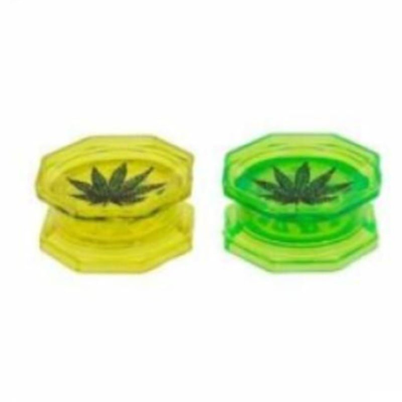 A 53mm Plastic Grinder with a cannabis leaf design, ideal for grinding herbs and spices, in a convenient and durable plastic construction.