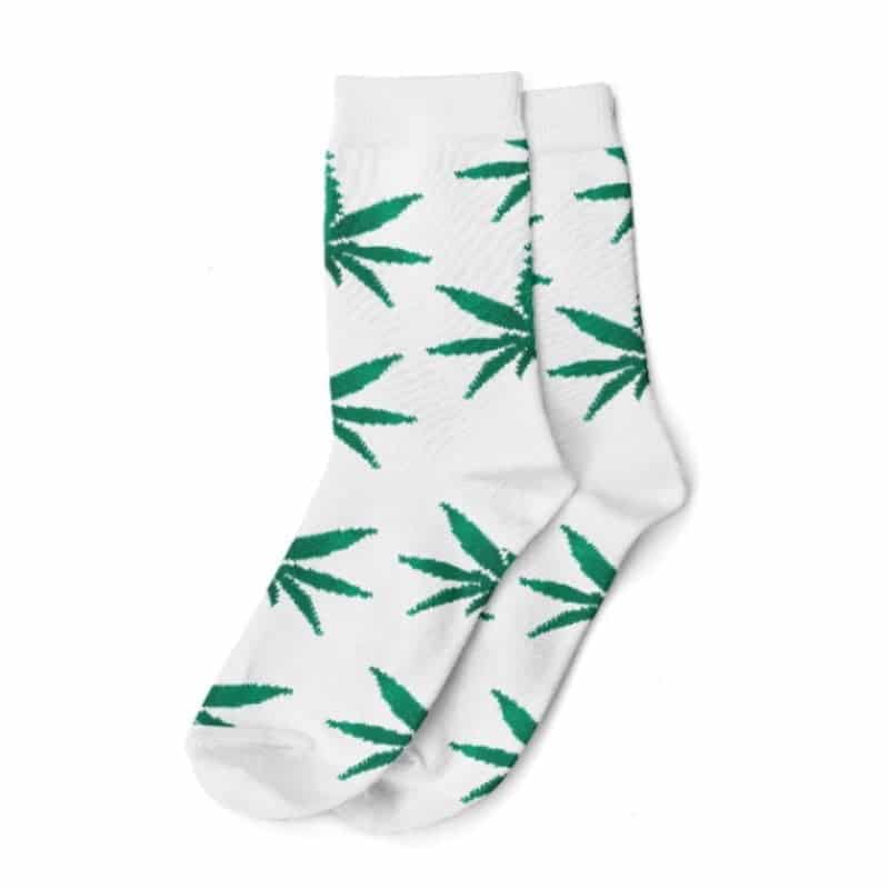 A pair of white and green weed-themed socks with intricate cannabis leaf patterns, perfect for cannabis enthusiasts.
